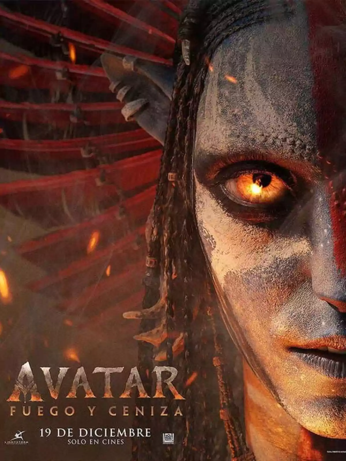 Promotional poster for the movie Avatar: Fire and Ash showing the face of a blue character with a glowing eye and fire details in the background Promotional poster for the movie Avatar: Fire and Ash showing the face of a blue character with a glowing eye and fire details in the background
