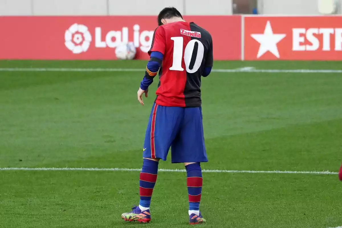 Soccer player on the field wearing a blue and red uniform with the number 10 on the back Soccer player on the field wearing a blue and red uniform with the number 10 on the back
