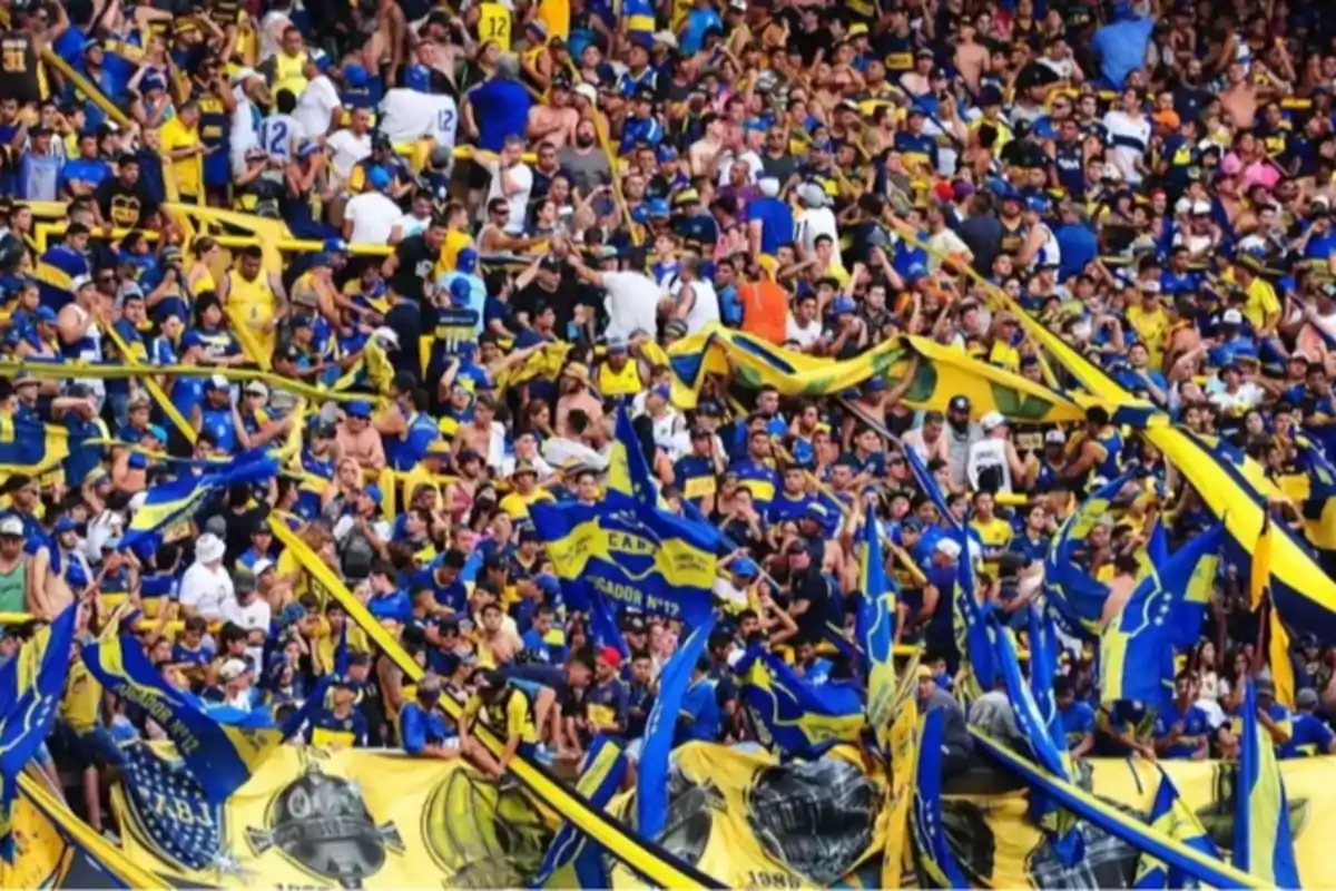 Soccer fans cheering in the stands with blue and yellow jerseys, flags, and ribbons Soccer fans cheering in the stands with blue and yellow jerseys, flags, and ribbons
