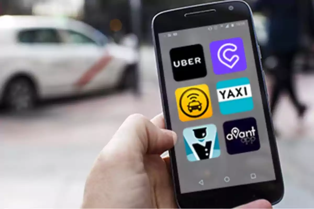 Persona sosteniendo un teléfono móvil que muestra varias aplicaciones de transporte y taxis en la pantalla, con un automóvil desenfocado al fondo.