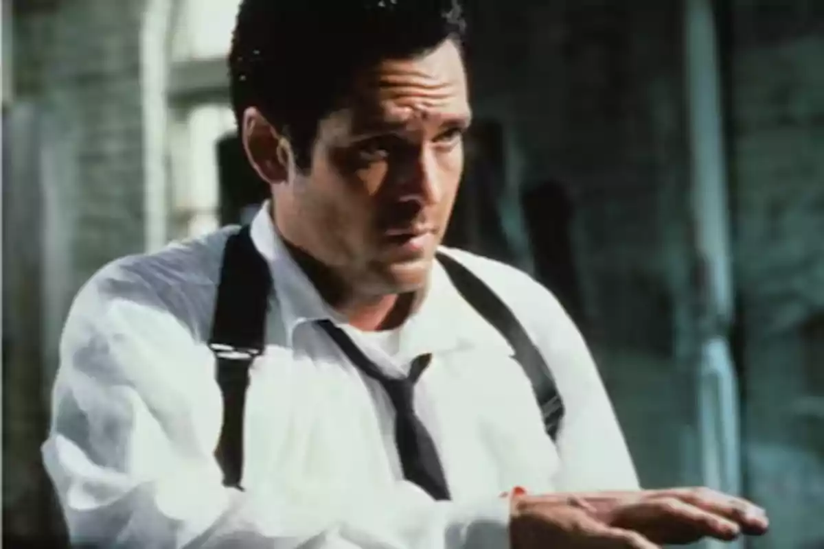 Man wearing a white jersey and black suspenders in a movie scene with a serious expression Man wearing a white jersey and black suspenders in a movie scene with a serious expression