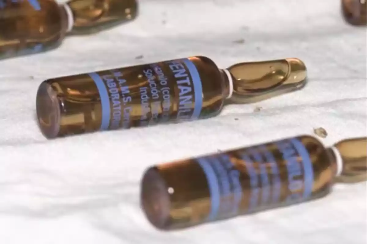 Amber glass vials with blue labels on a white surface Amber glass vials with blue labels on a white surface