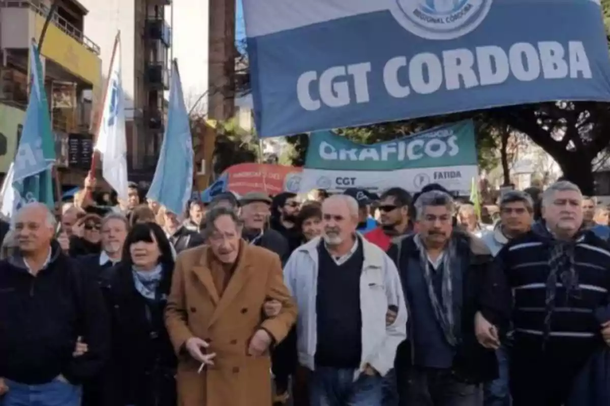 Demonstration of people marching down the street with flags and banners of the CGT Córdoba Demonstration of people marching down the street with flags and banners of the CGT Córdoba