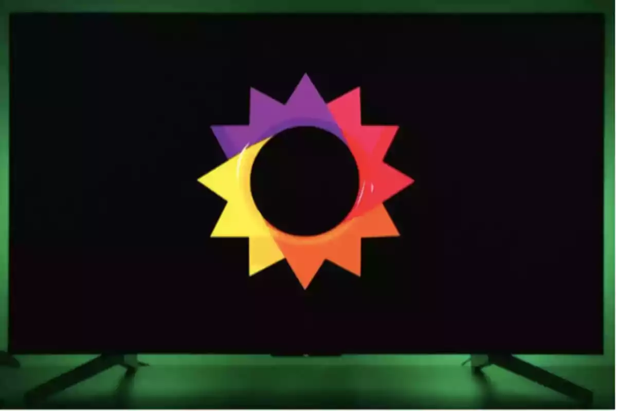Screen with a black background displaying a stylized sun in yellow, orange, red, and purple colors with a black circle in the center Screen with a black background displaying a stylized sun in yellow, orange, red, and purple colors with a black circle in the center