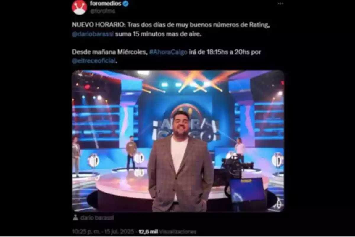 A man in a plaid jacket is standing in the center of a brightly lit television set with colorful lights and the A man in a plaid jacket is standing in the center of a brightly lit television set with colorful lights and the