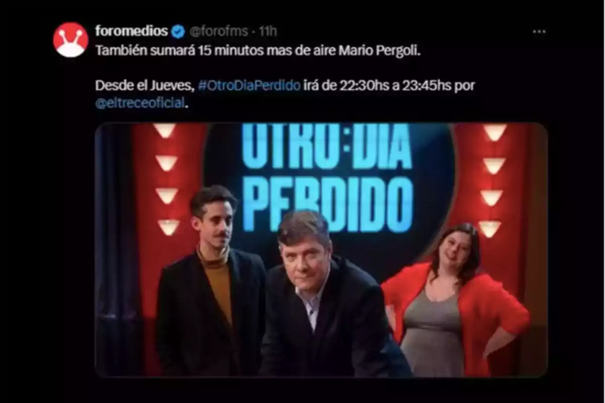 Three people pose on a television set with a background sign that says Three people pose on a television set with a background sign that says