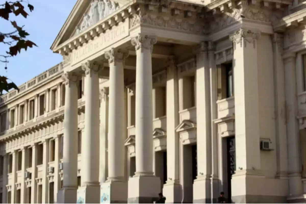 Facade of an old building with columns and classical architectural details where it reads Palace of Justice Facade of an old building with columns and classical architectural details where it reads Palace of Justice