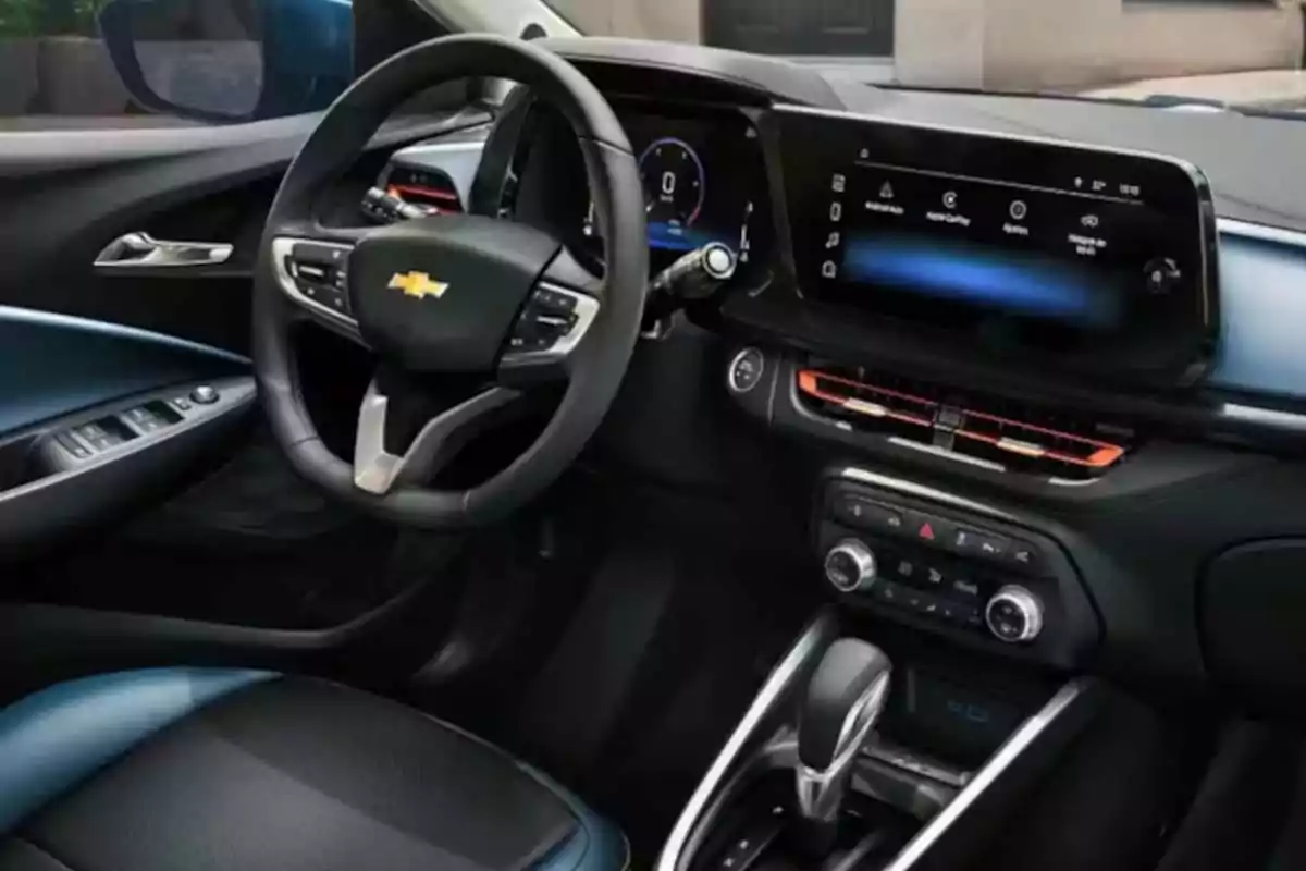 Interior moderno de un automóvil Chevrolet con volante multifunción, pantalla digital y controles electrónicos en la consola central Interior moderno de un automóvil Chevrolet con volante multifunción, pantalla digital y controles electrónicos en la consola central