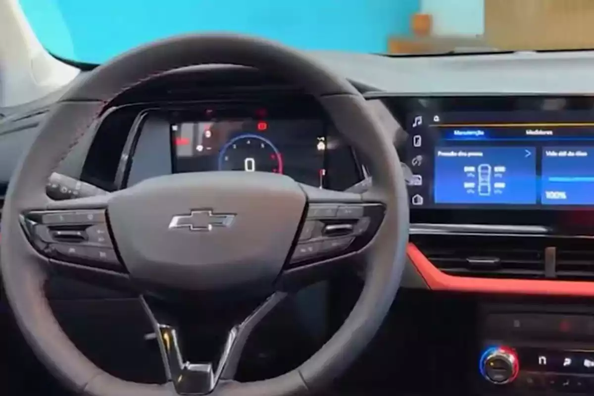 Steering wheel of a Chevrolet car with a digital dashboard and central screen on displaying vehicle information Steering wheel of a Chevrolet car with a digital dashboard and central screen on displaying vehicle information