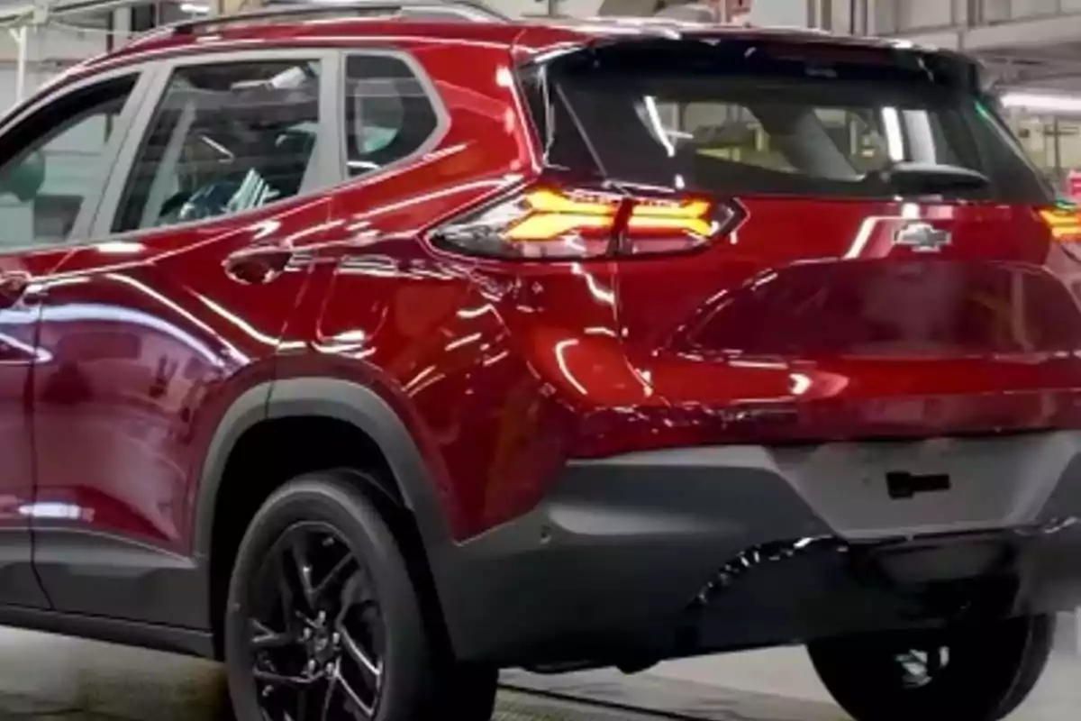 Red SUV with black rims, rear view inside a factory Red SUV with black rims, rear view inside a factory