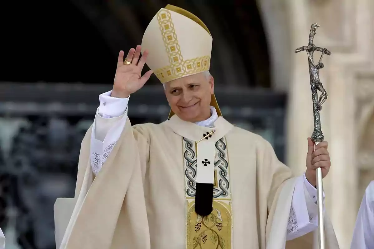 Catholic bishop dressed in light liturgical vestments, holding a crosier and greeting with his right hand. Catholic bishop dressed in light liturgical vestments, holding a crosier and greeting with his right hand.