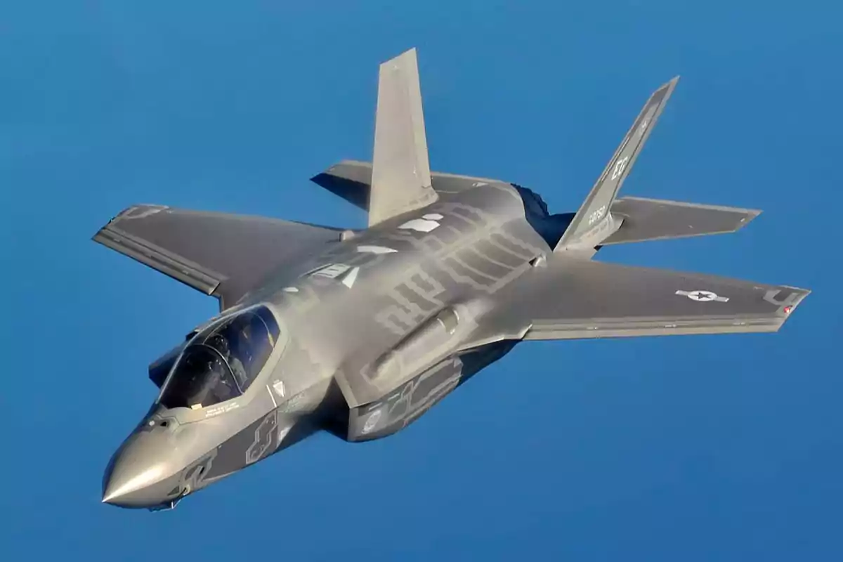 Stealth fighter jet flying in the blue sky Stealth fighter jet flying in the blue sky