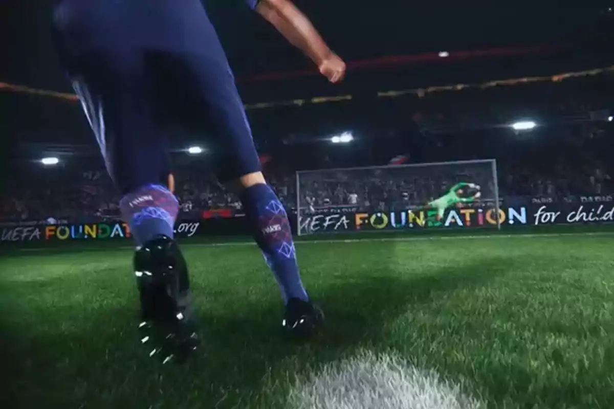 A player is about to kick a ball toward the goal as the goalkeeper dives to try to stop it in a brightly lit stadium full of spectators. A player is about to kick a ball toward the goal as the goalkeeper dives to try to stop it in a brightly lit stadium full of spectators.