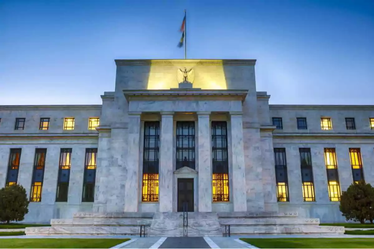 Marble government building with columns and windows lit up at sunset Marble government building with columns and windows lit up at sunset