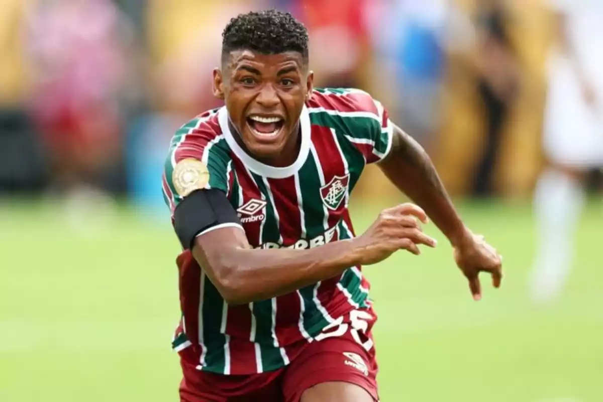 Soccer player in a Fluminense uniform celebrating on the field during a match Soccer player in a Fluminense uniform celebrating on the field during a match