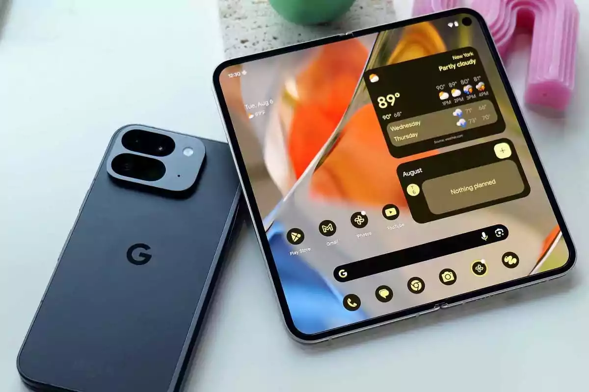 Two Google Pixel phones, one foldable opened showing the main screen with widgets and apps, and another closed showing the back with the Google logo and the camera module. Two Google Pixel phones, one foldable opened showing the main screen with widgets and apps, and another closed showing the back with the Google logo and the camera module.