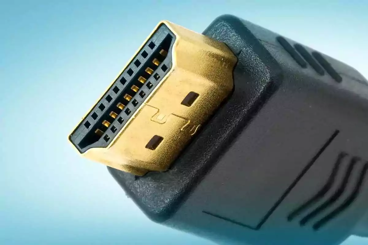 Close-up HDMI connector with gold details and blurred blue background Close-up HDMI connector with gold details and blurred blue background