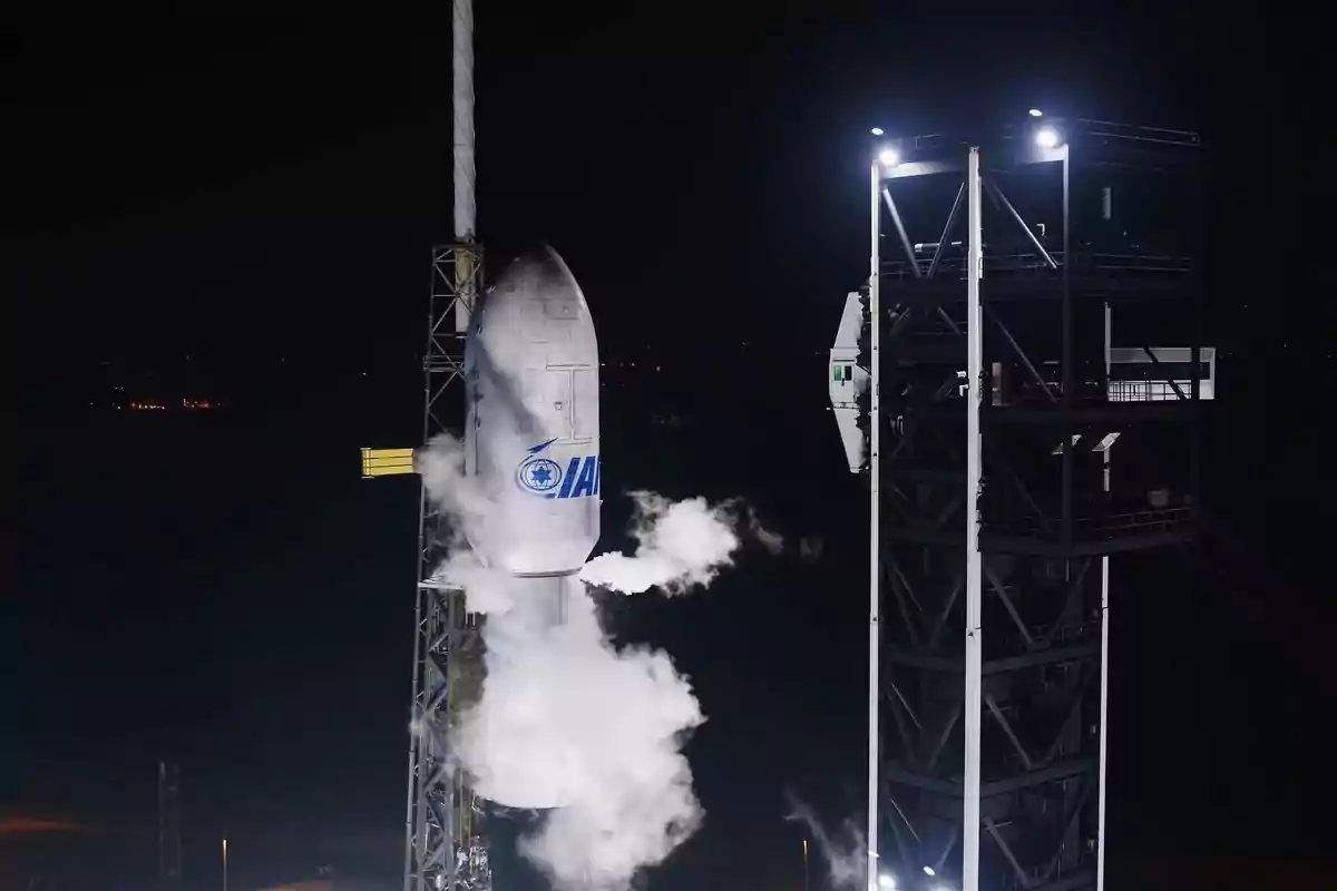 Rocket on a launch pad at night with vapor coming from its structure