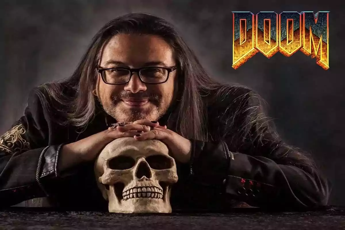 Long-haired man with glasses smiling while resting his hands on a skull with the DOOM logo in the top right corner Long-haired man with glasses smiling while resting his hands on a skull with the DOOM logo in the top right corner
