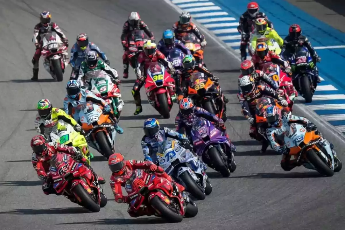 Group of motorcyclists competing in a race on a paved circuit Group of motorcyclists competing in a race on a paved circuit