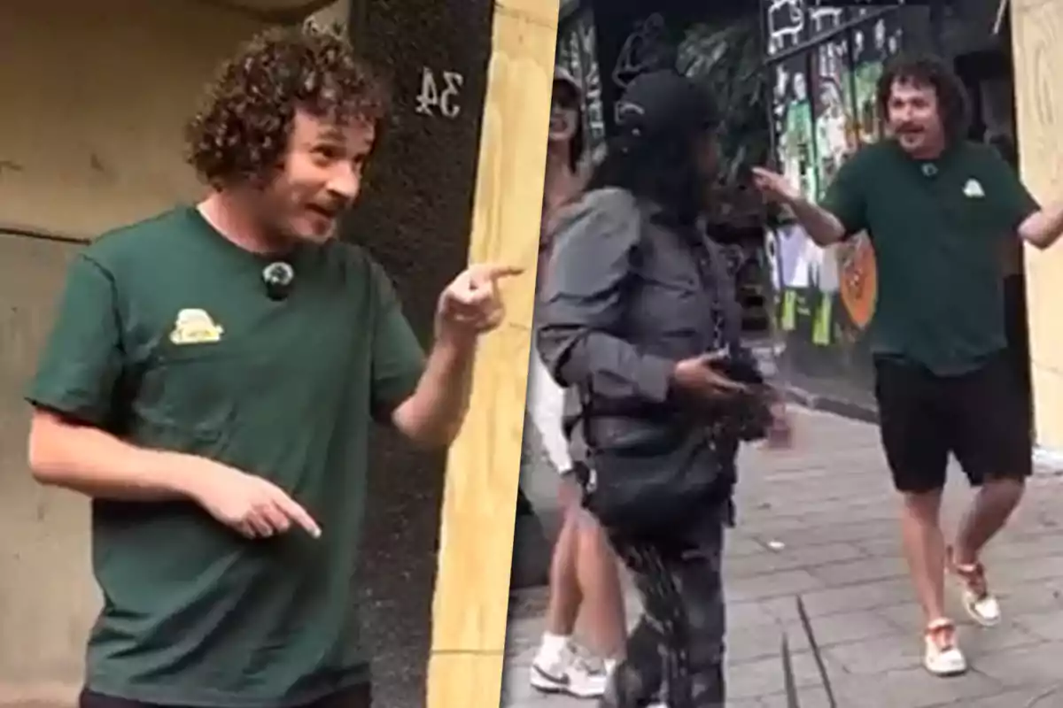 Curly-haired man in a green t-jersey interacting with someone on the street while gesturing with his hands