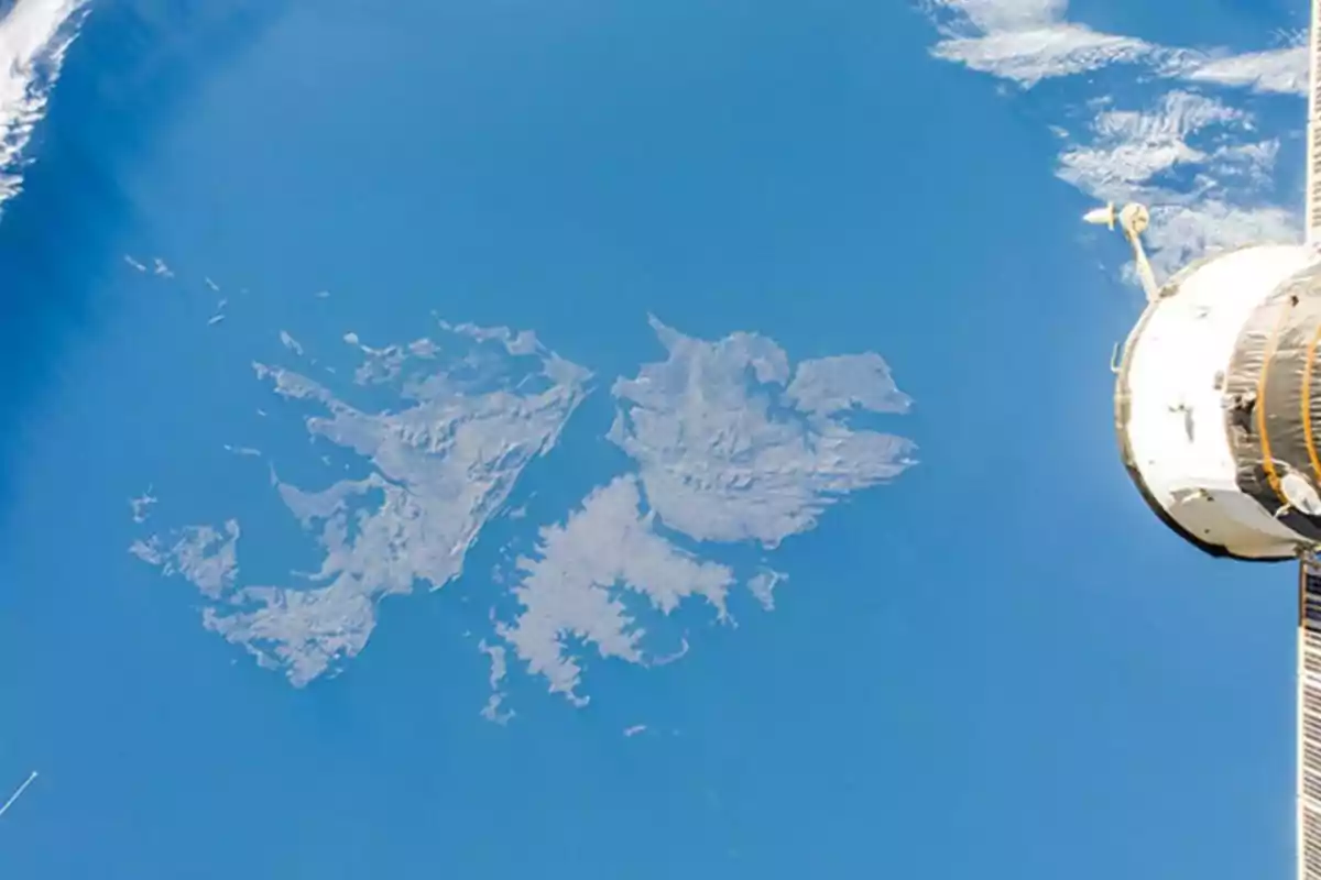 Aerial view of the Falkland Islands surrounded by the Atlantic Ocean with part of a spacecraft in the right corner Aerial view of the Falkland Islands surrounded by the Atlantic Ocean with part of a spacecraft in the right corner