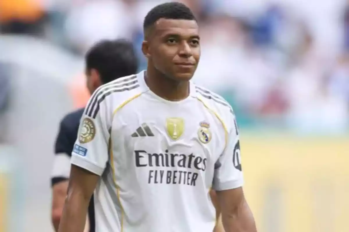 Soccer player wearing Real Madrid’s white uniform on the field Soccer player wearing Real Madrid’s white uniform on the field