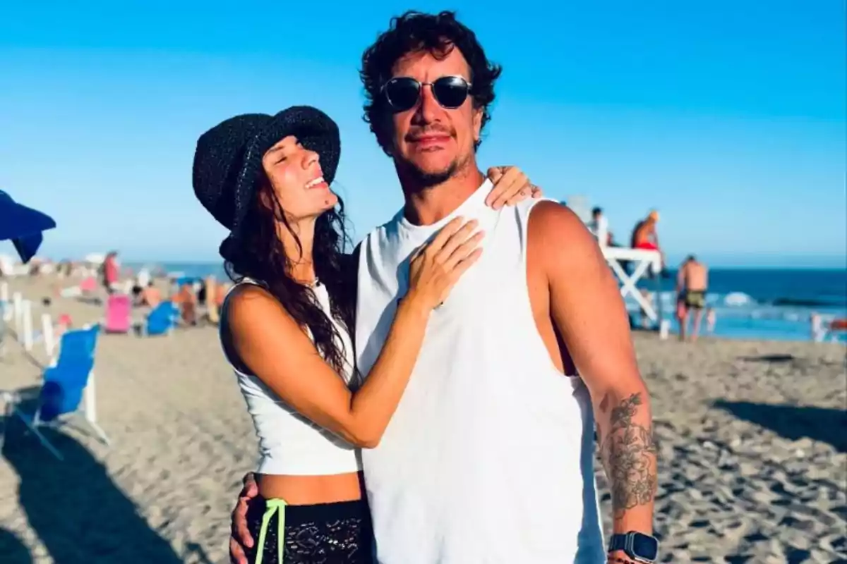 Couple hugging on the beach enjoying a sunny day
