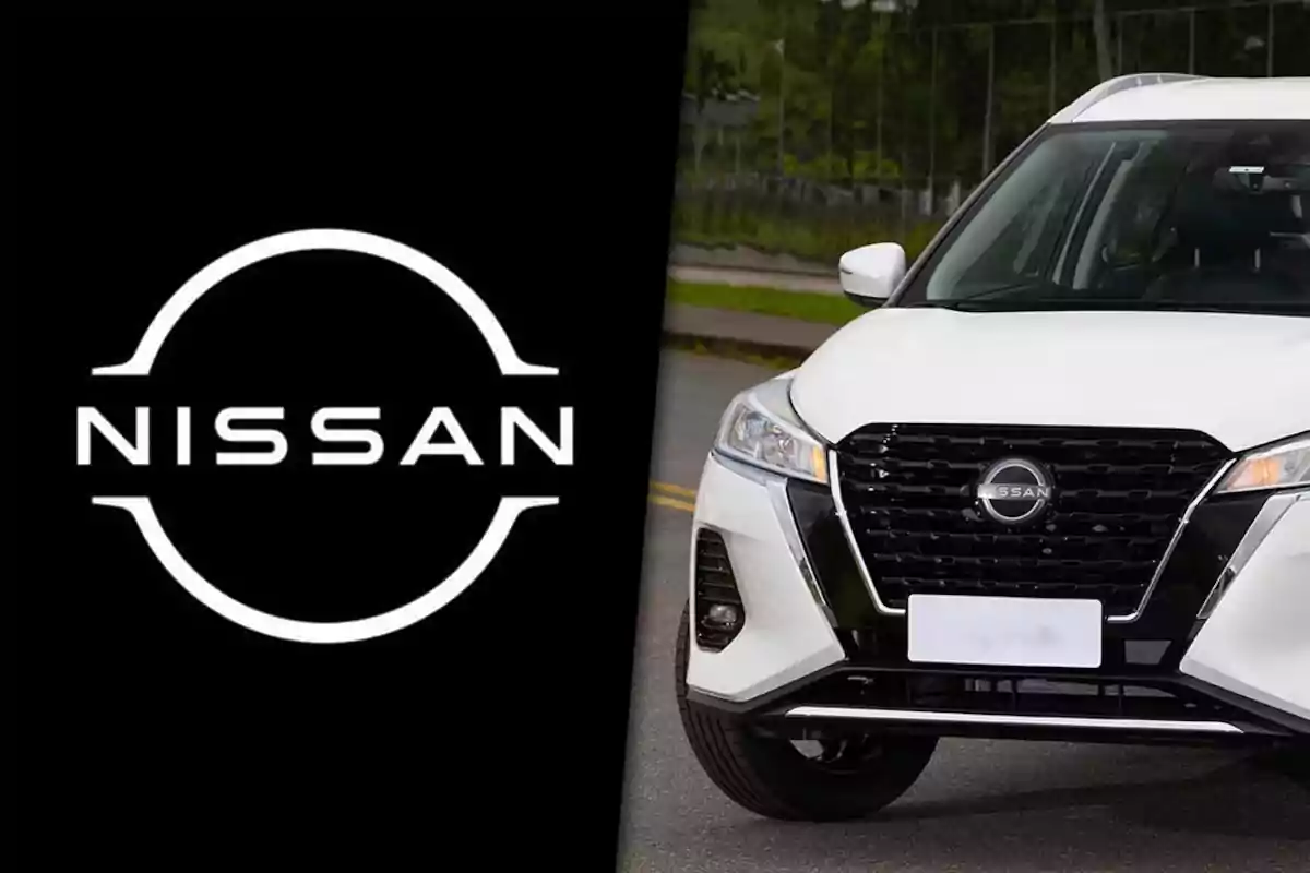Nissan logo next to the front of a white car of the same brand parked on the street