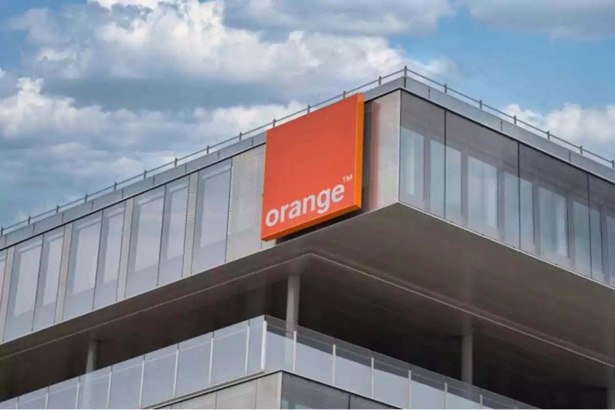Modern building with an orange Orange company sign on the facade Modern building with an orange Orange company sign on the facade