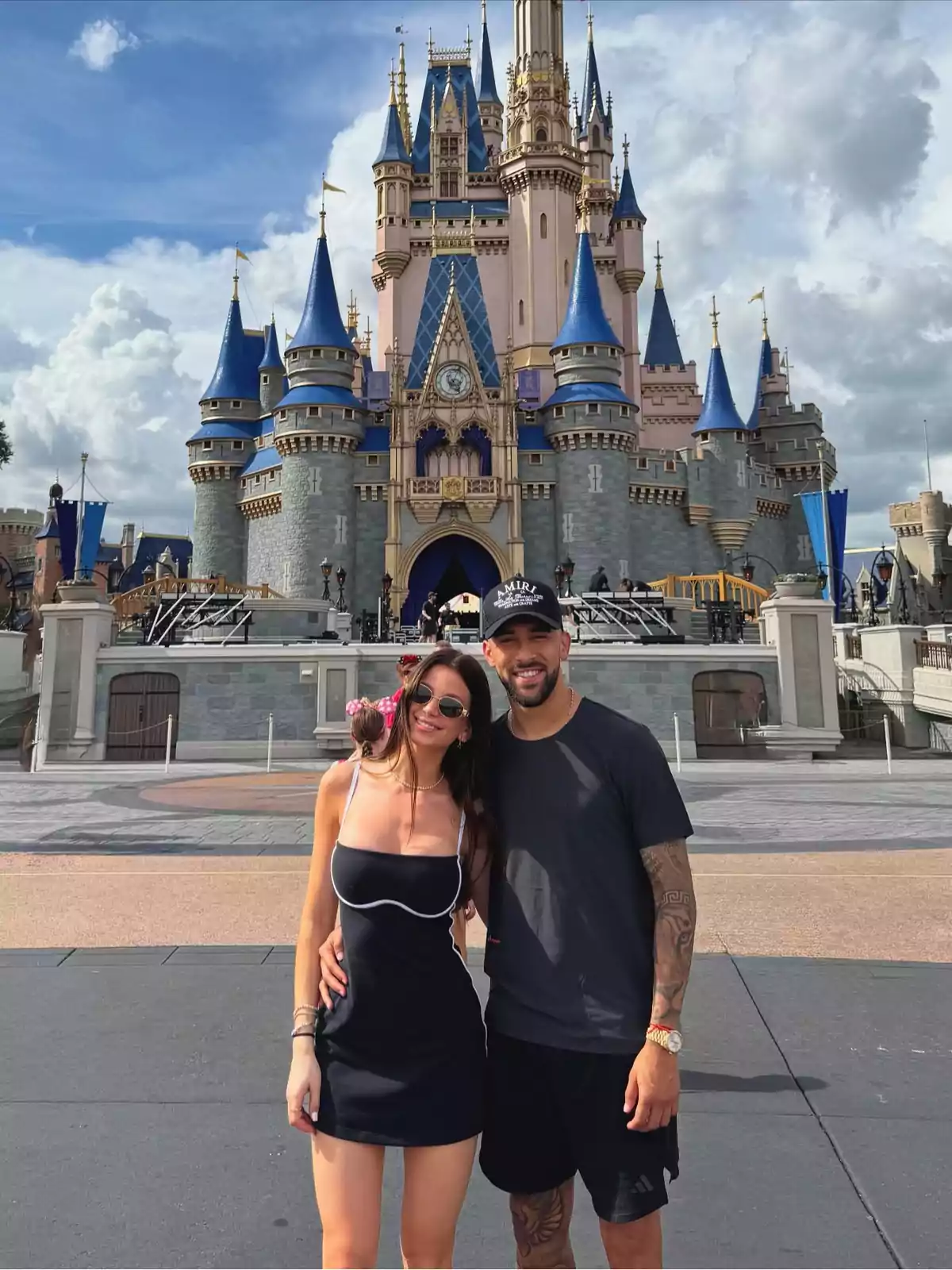 Couple posing in front of the Disney castle on a sunny day Couple posing in front of the Disney castle on a sunny day