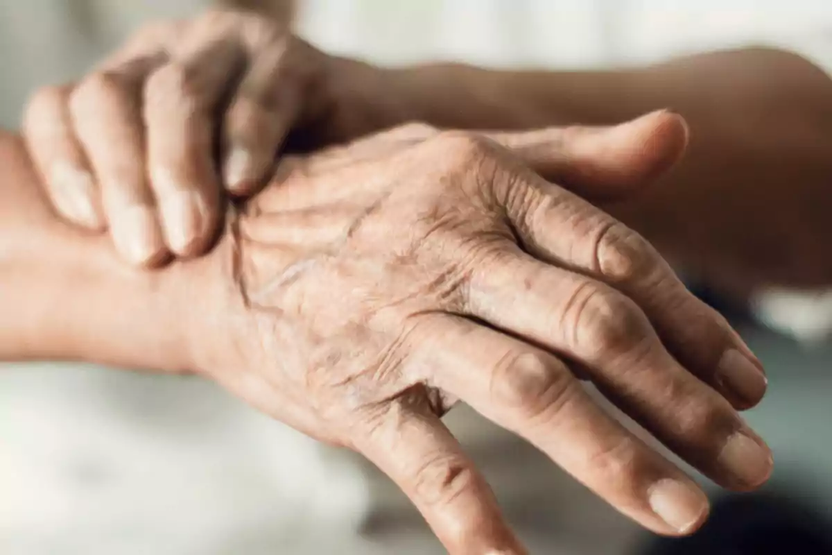 Hands of an elderly person resting one on top of the other Hands of an elderly person resting one on top of the other