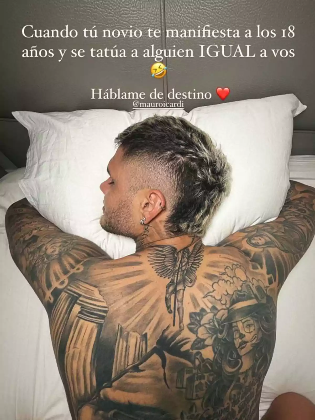 Man lying face down on a bed showing his back covered in tattoos, including one of a woman with a hat and flowers, accompanied by a humorous text about fate and tattoos. Man lying face down on a bed showing his back covered in tattoos, including one of a woman with a hat and flowers, accompanied by a humorous text about fate and tattoos.