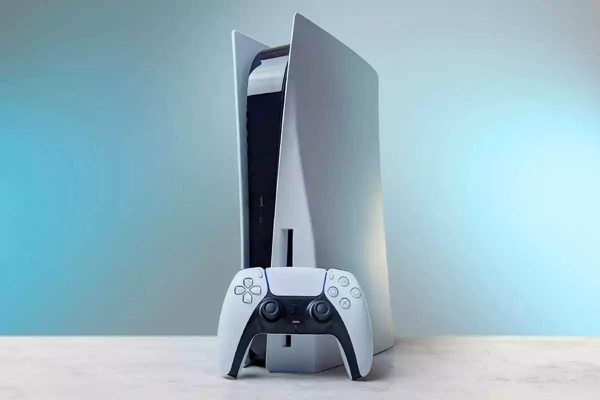 PlayStation 5 video game console with a DualSense controller on a light surface and a blurred blue background PlayStation 5 video game console with a DualSense controller on a light surface and a blurred blue background