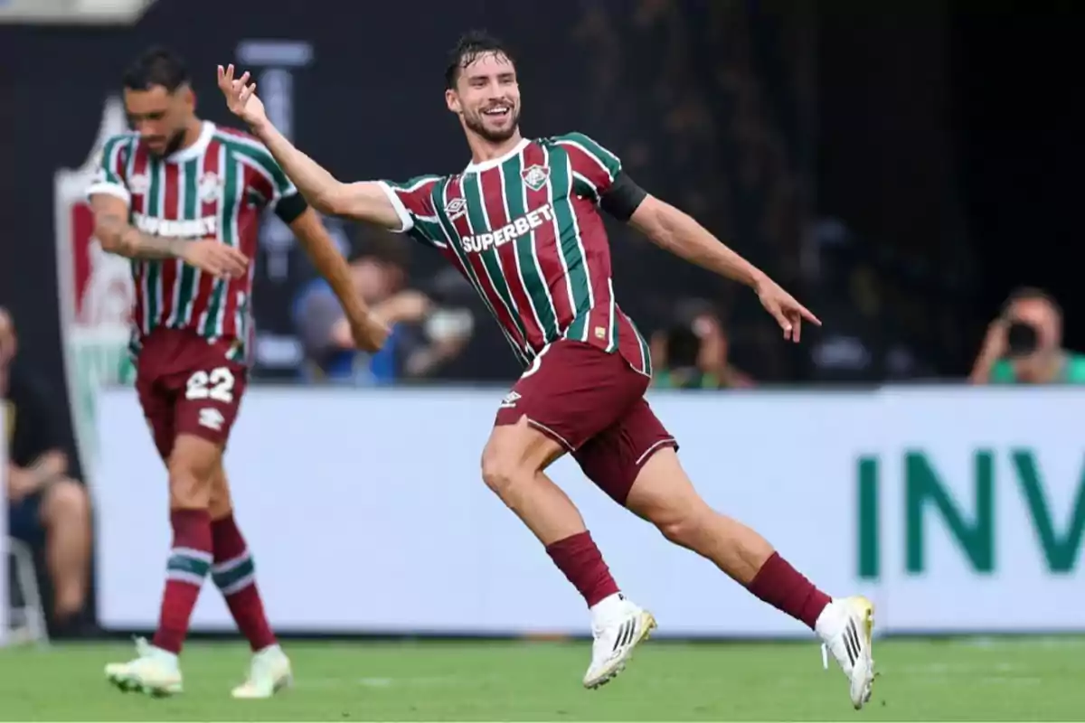 Soccer player celebrating a goal in a stadium while wearing a green, red, and white striped uniform Soccer player celebrating a goal in a stadium while wearing a green, red, and white striped uniform