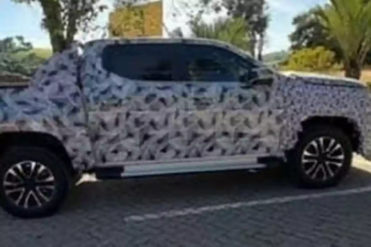 Pickup truck covered with test camouflage parked in an outdoor location Pickup truck covered with test camouflage parked in an outdoor location