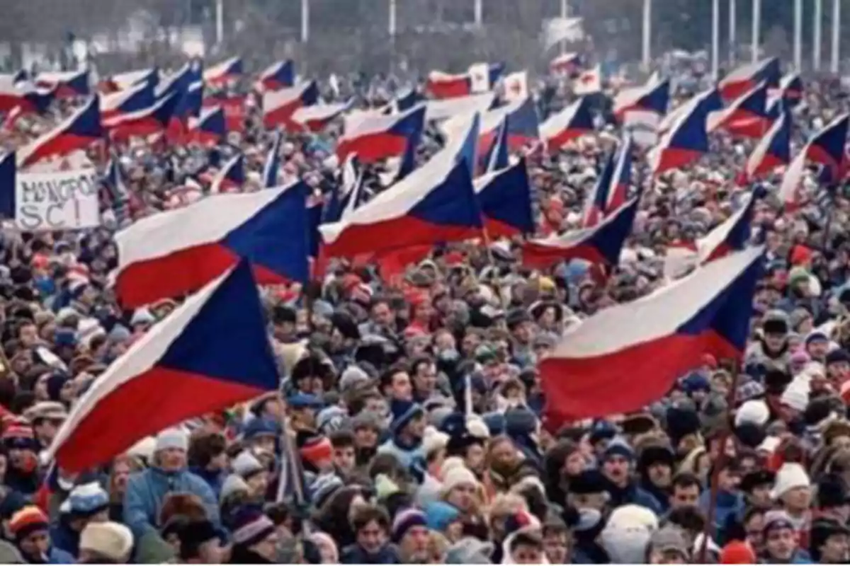 Crowd of people gathered at a demonstration waving numerous flags of the Czech Republic Crowd of people gathered at a demonstration waving numerous flags of the Czech Republic
