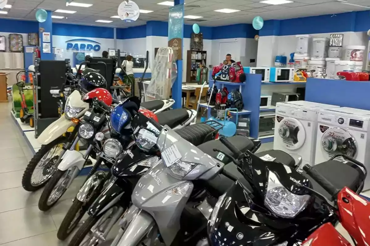 Motorcycles lined up inside an appliance and home goods store Motorcycles lined up inside an appliance and home goods store