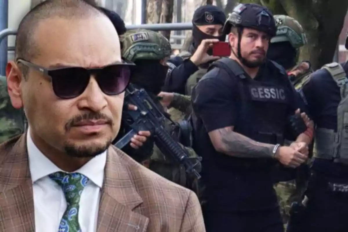 Hombre con gafas de sol y traje al frente mientras al fondo varios policías fuertemente armados escoltan a un detenido con chaleco táctico