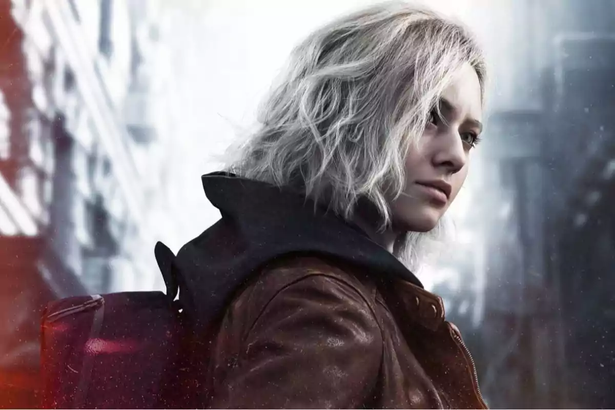 Short, wavy blonde-haired woman with a brown jacket and a backpack in a blurred urban setting