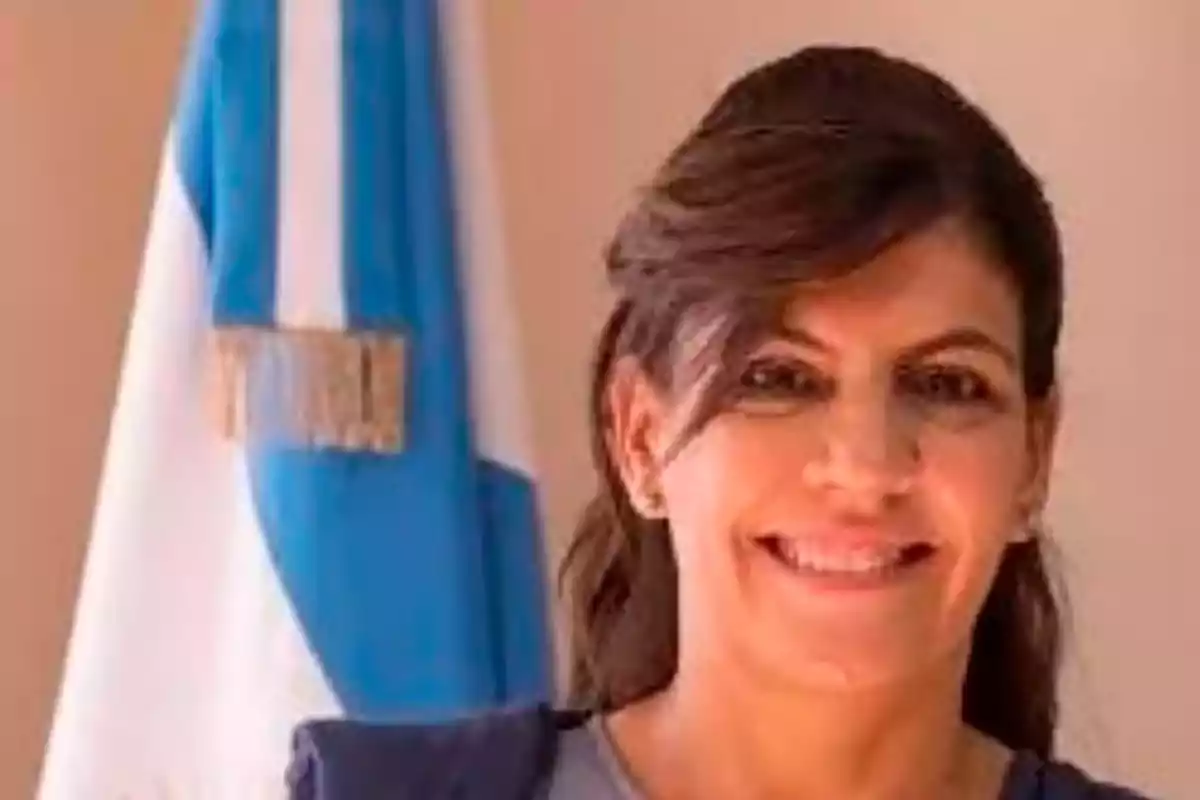 Woman smiling with an Argentine flag in the background Woman smiling with an Argentine flag in the background