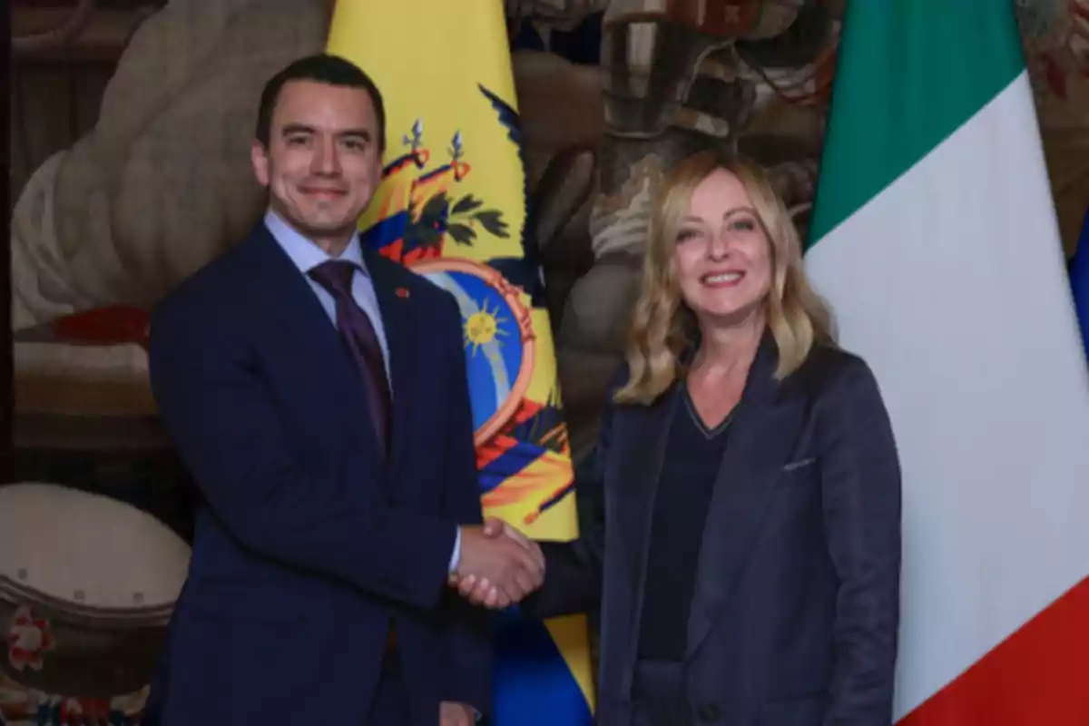 Two people standing and shaking hands in front of the flags of Ecuador and Italy Two people standing and shaking hands in front of the flags of Ecuador and Italy