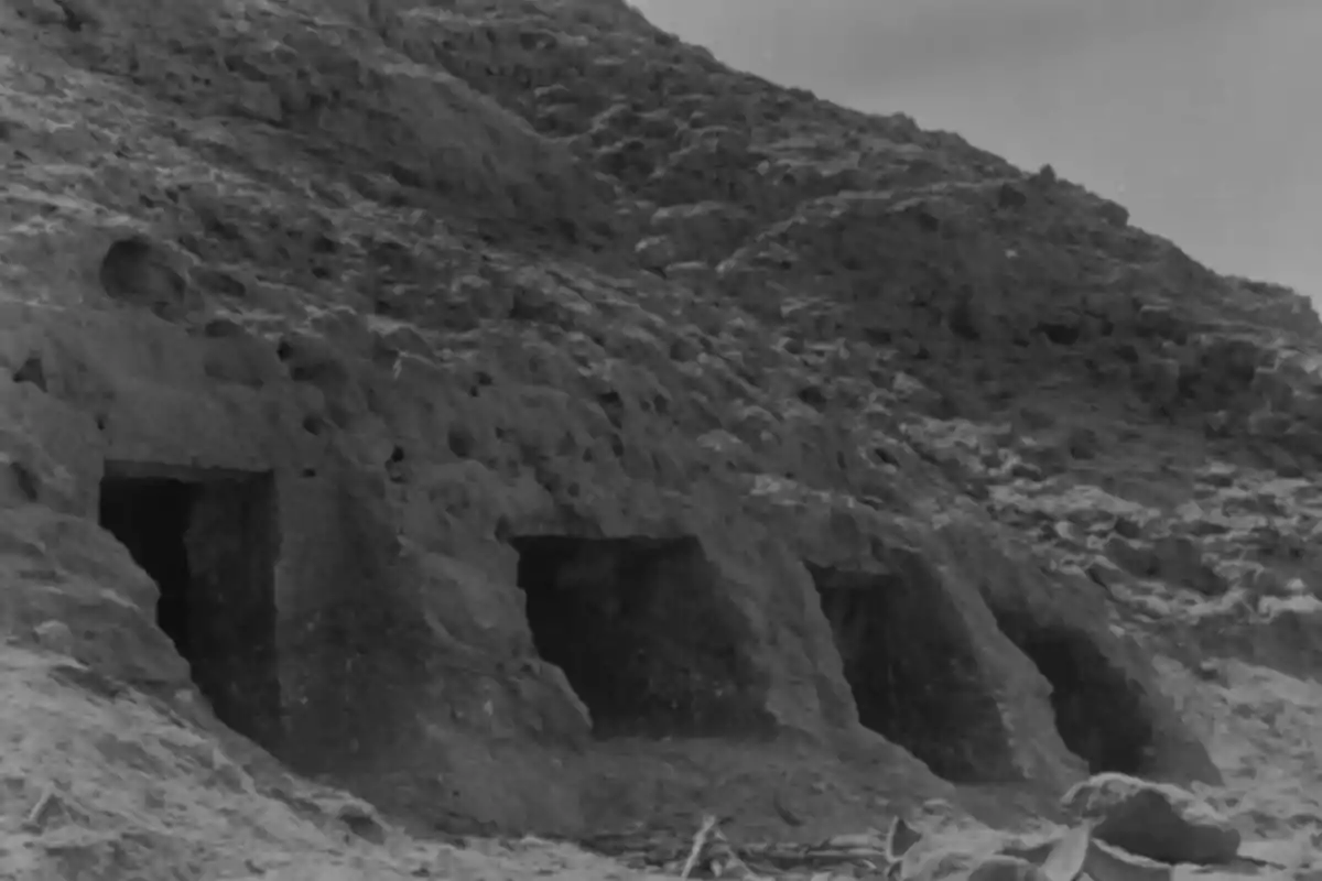 Tombs carved into the side of a rocky hillside in an arid landscape Tombs carved into the side of a rocky hillside in an arid landscape