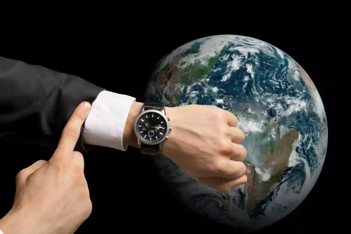 Person pointing at their wristwatch with the Earth in the background