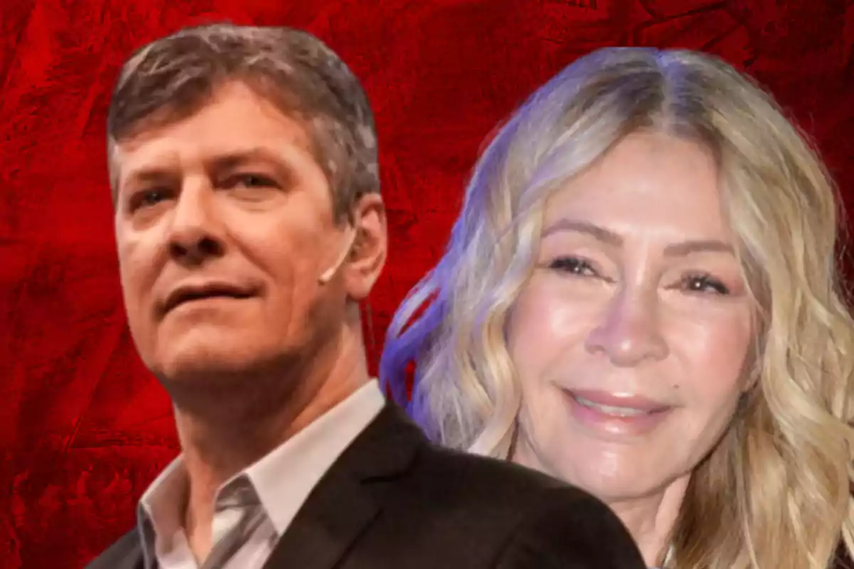 Two people pose in front of a red background.