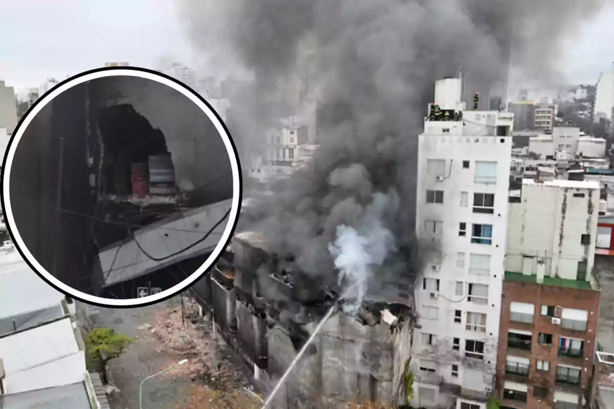 Building on fire with a large column of black smoke and firefighters working to extinguish the blaze, with an inset showing a detail of the damaged structure and barrels stored inside.