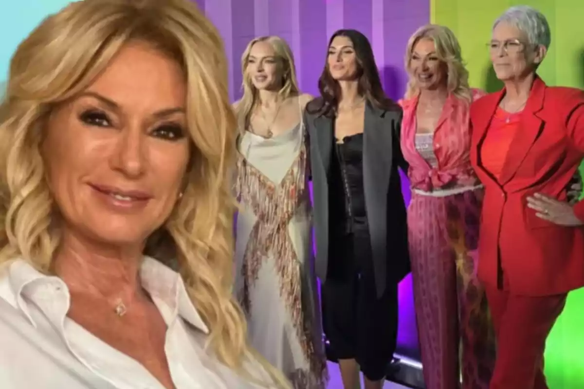 A blonde woman in the foreground smiles while in the background five women pose together in front of a colorful backdrop.
