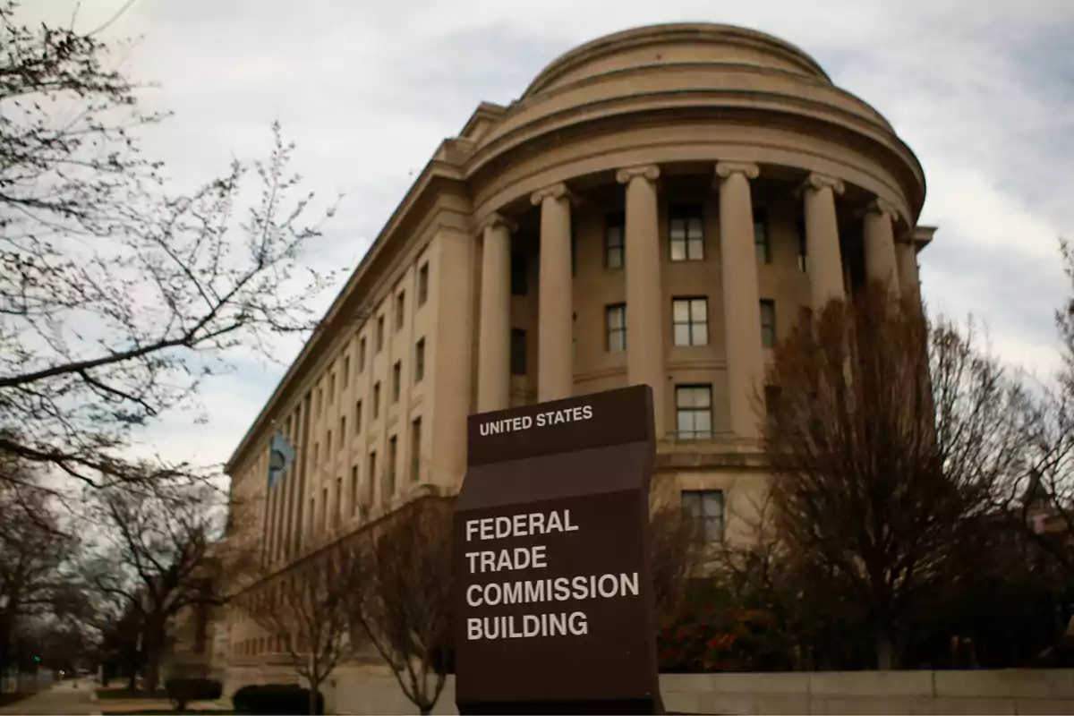 United States Federal Trade Commission building with a sign in the foreground and leafless trees around it United States Federal Trade Commission building with a sign in the foreground and leafless trees around it