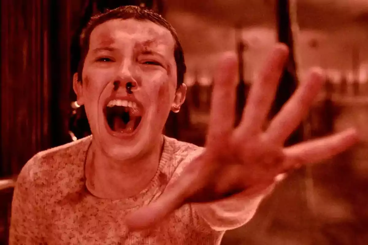 Person with a distressed expression reaching their hand forward in a dark, reddish environment Person with a distressed expression reaching their hand forward in a dark, reddish environment