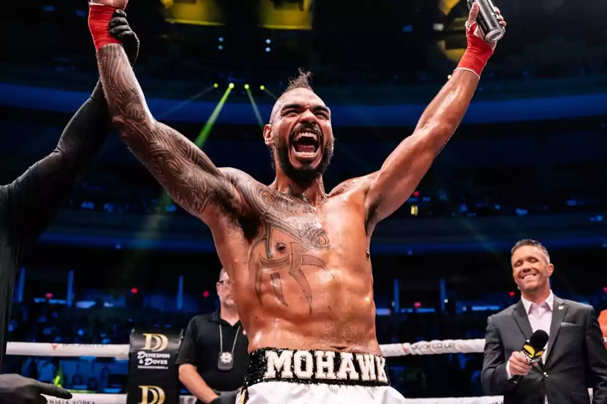 Boxer celebrating victory in the ring with arms raised and a triumphant expression Boxer celebrating victory in the ring with arms raised and a triumphant expression